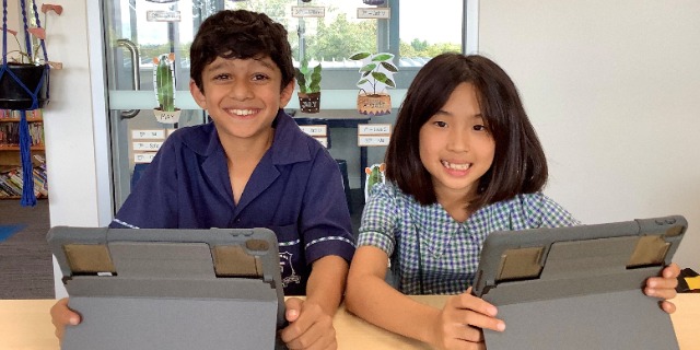 Students using tablets together at St Pius X Primary School, highlighting collaborative digital learning, engagement and confidence in the classroom
